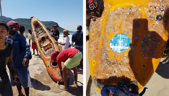 Image of barnacle-encrusted kayak washed up on Fish Hoek beach in Cape Town