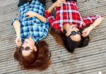 Image of girls lying on the deck laughing