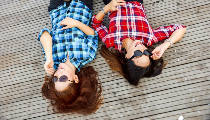 Image of girls lying on the deck laughing