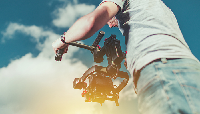 Taking Video Shoots Using DSLR Digital Camera Installed on the Pro Gimbal. Motion Picture Equipment and Work.