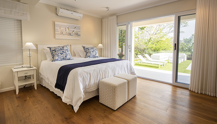 Elegant en-suite bedroom at Number Eleven with king-size bed and sliding doors opening to the garden
