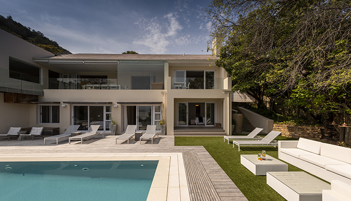 Spacious luxury villa with pool, sun loungers, and outdoor lounge at Number Eleven