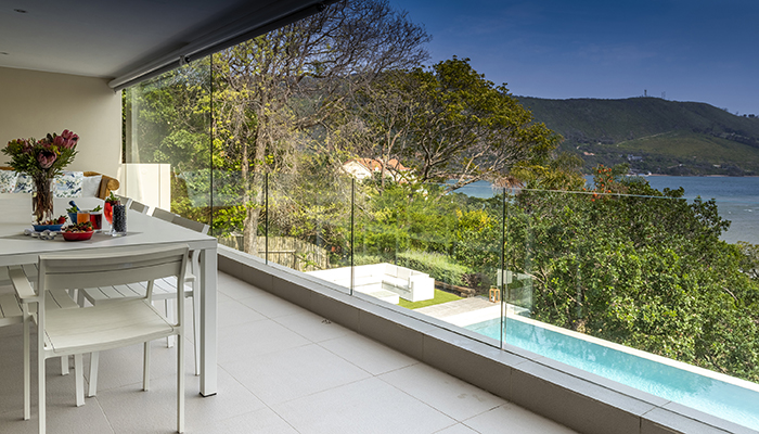 Private dining area and pool with glass railing overlooking Knysna lagoon at Number Eleven villa