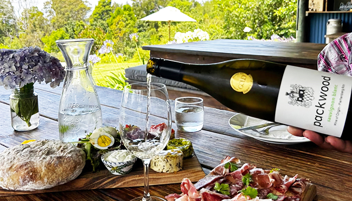 Wine being poured next to a charcuterie board at Packwood Wine & Country Estate