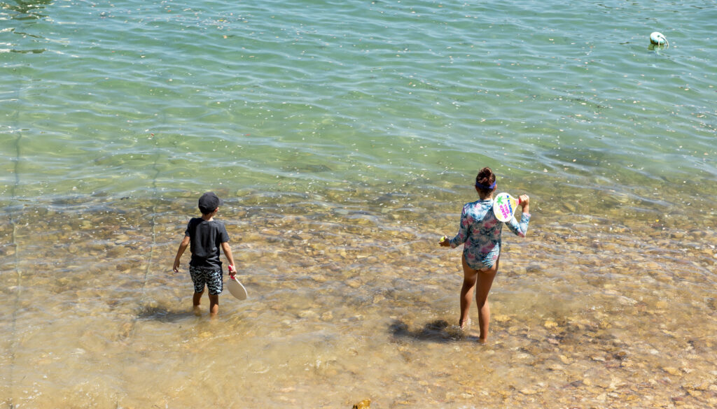 Children playing on the lagoon-side beach at The Milkwood Collection in Knysna