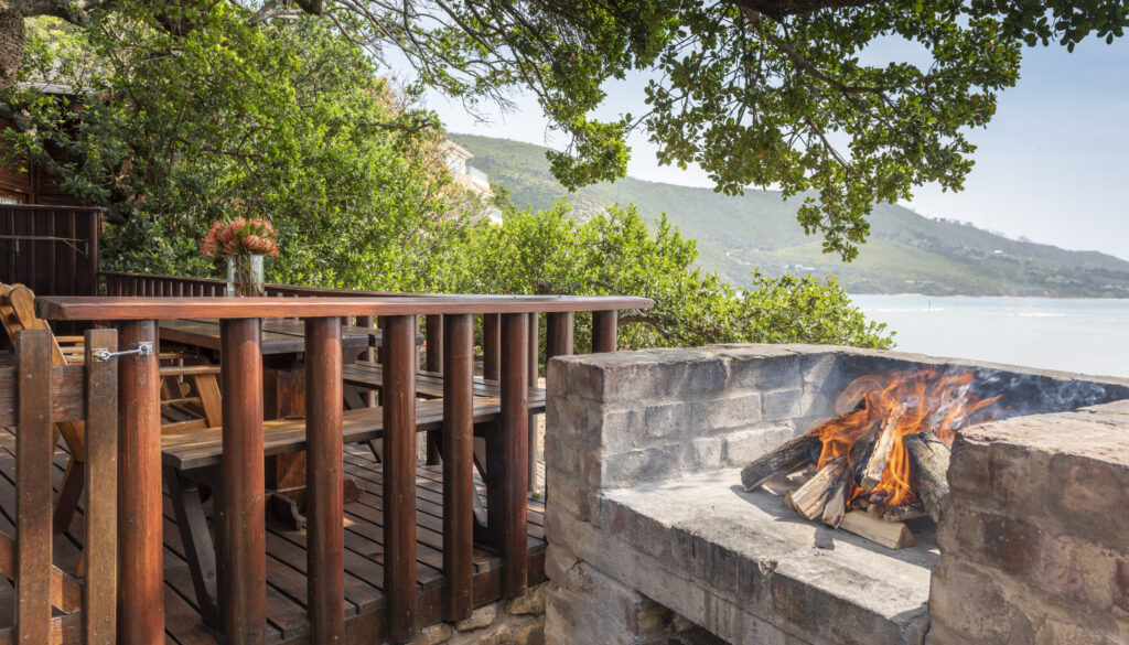 Braai (BBQ) on the deck of an Under Milkwood waterfront chalet beside the Knysna Lagoon