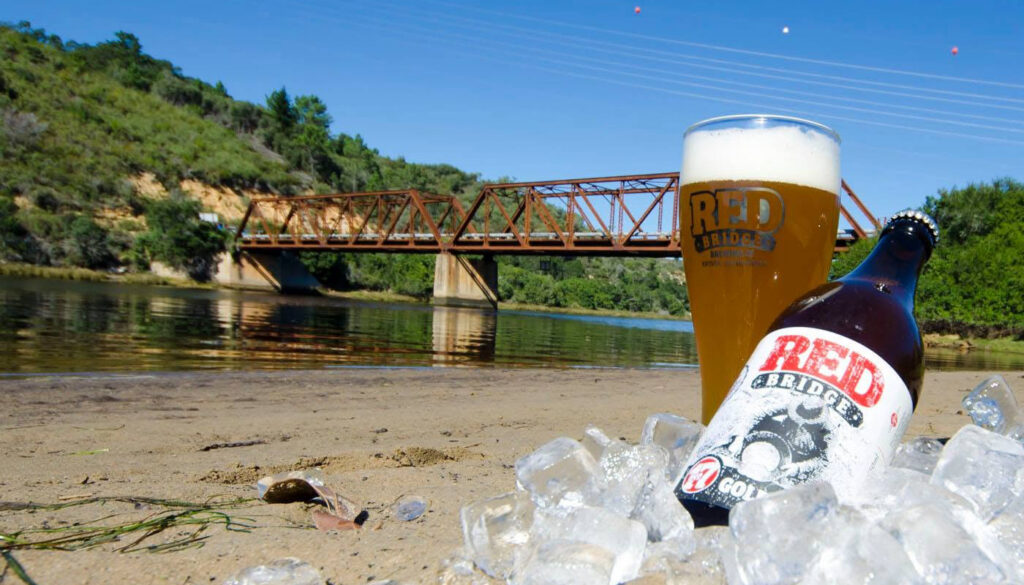 Red Bridge craft beer beside the historic red railway bridge in Knysna