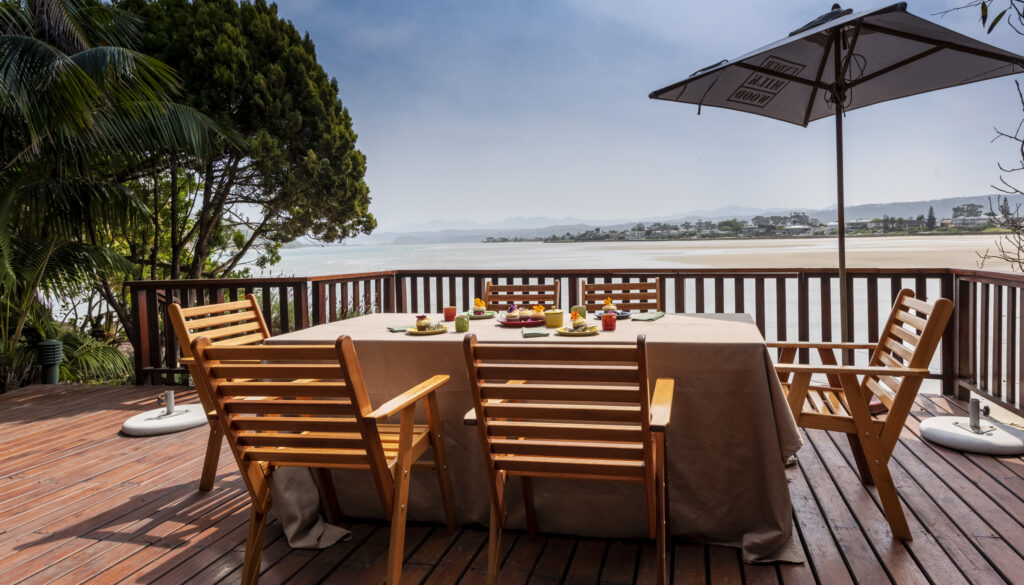 Breakfast table on the wooden deck at Paquita overlooking the Knysna Lagoon