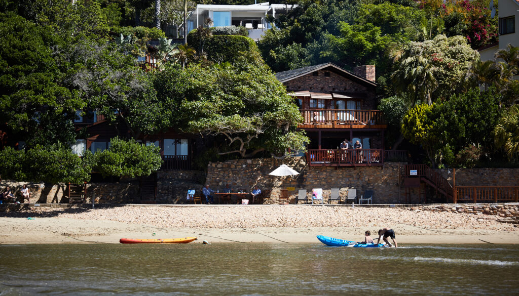 Paquita viewed from the Knysna Lagoon with the beach in front