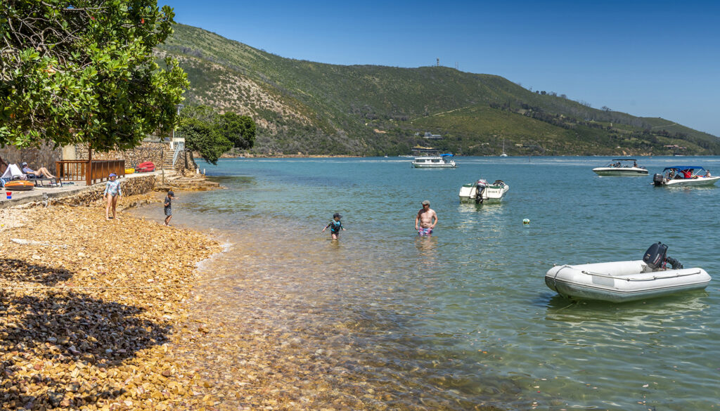 Calm water and small boats on the Knysna Lagoon beside The Milkwood Collection
